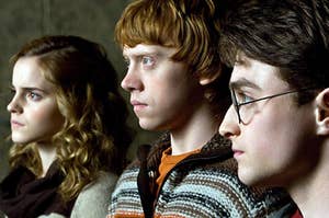 Hermione Granger, Ron Weasley, and Harry Potter look off into the distance