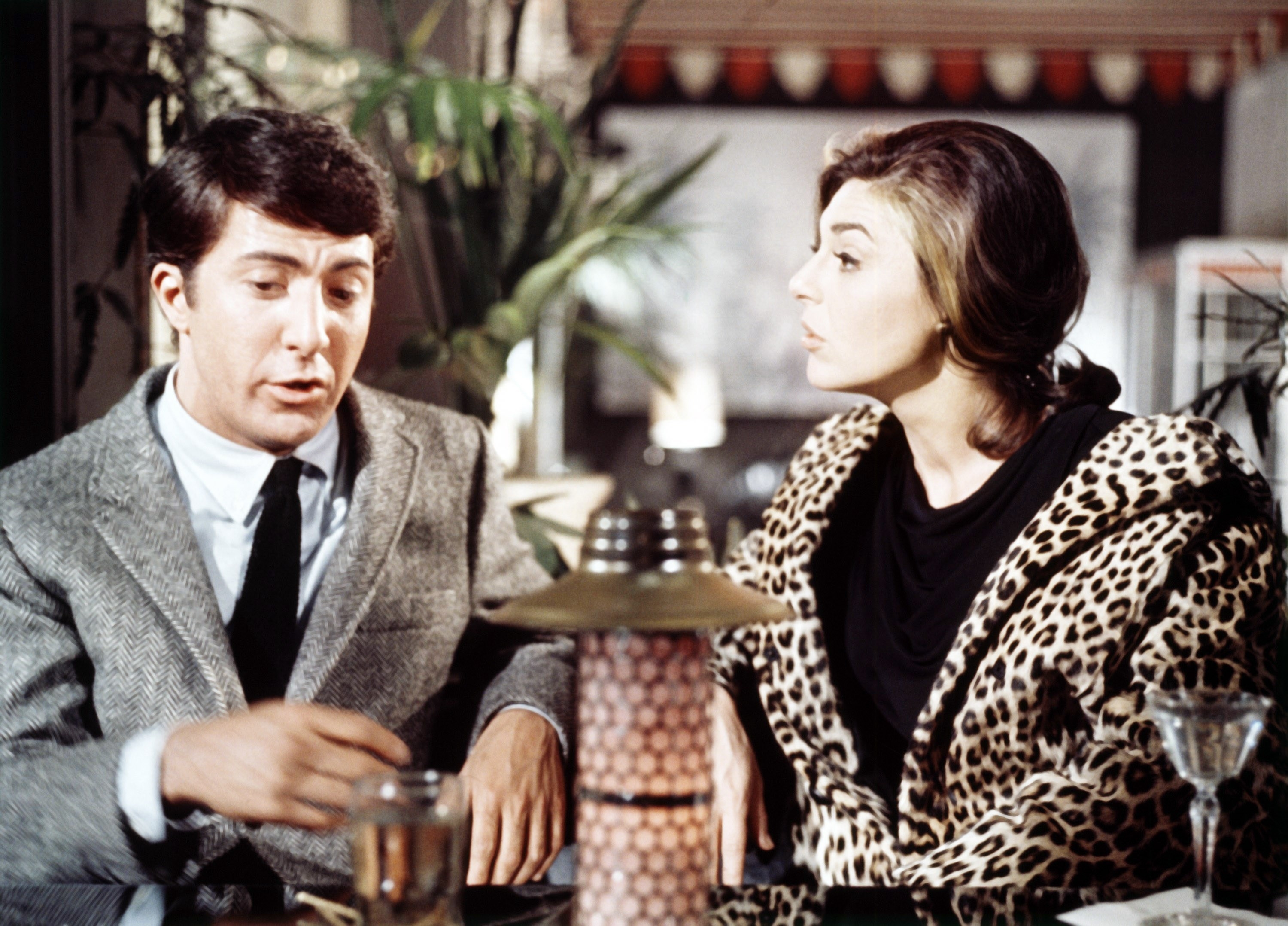 Dustin Hoffman talks with Anne Bancroft over a drink
