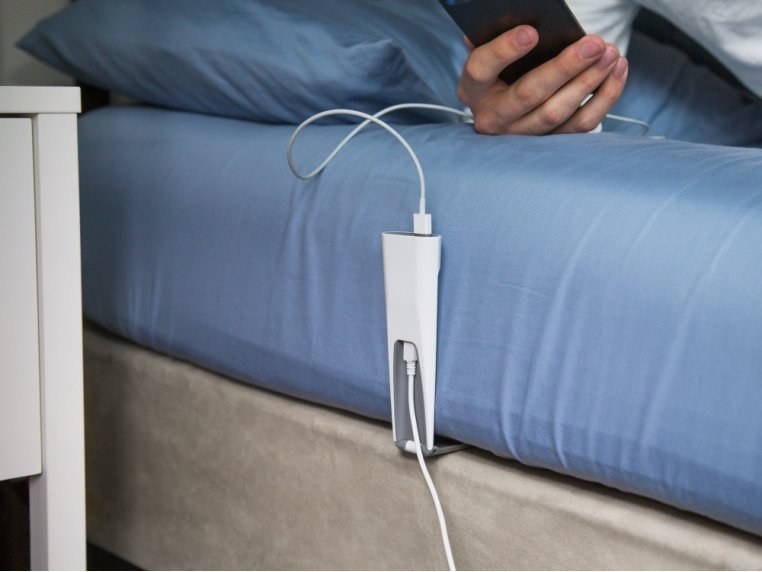 charging porch wedged in between mattress and bed