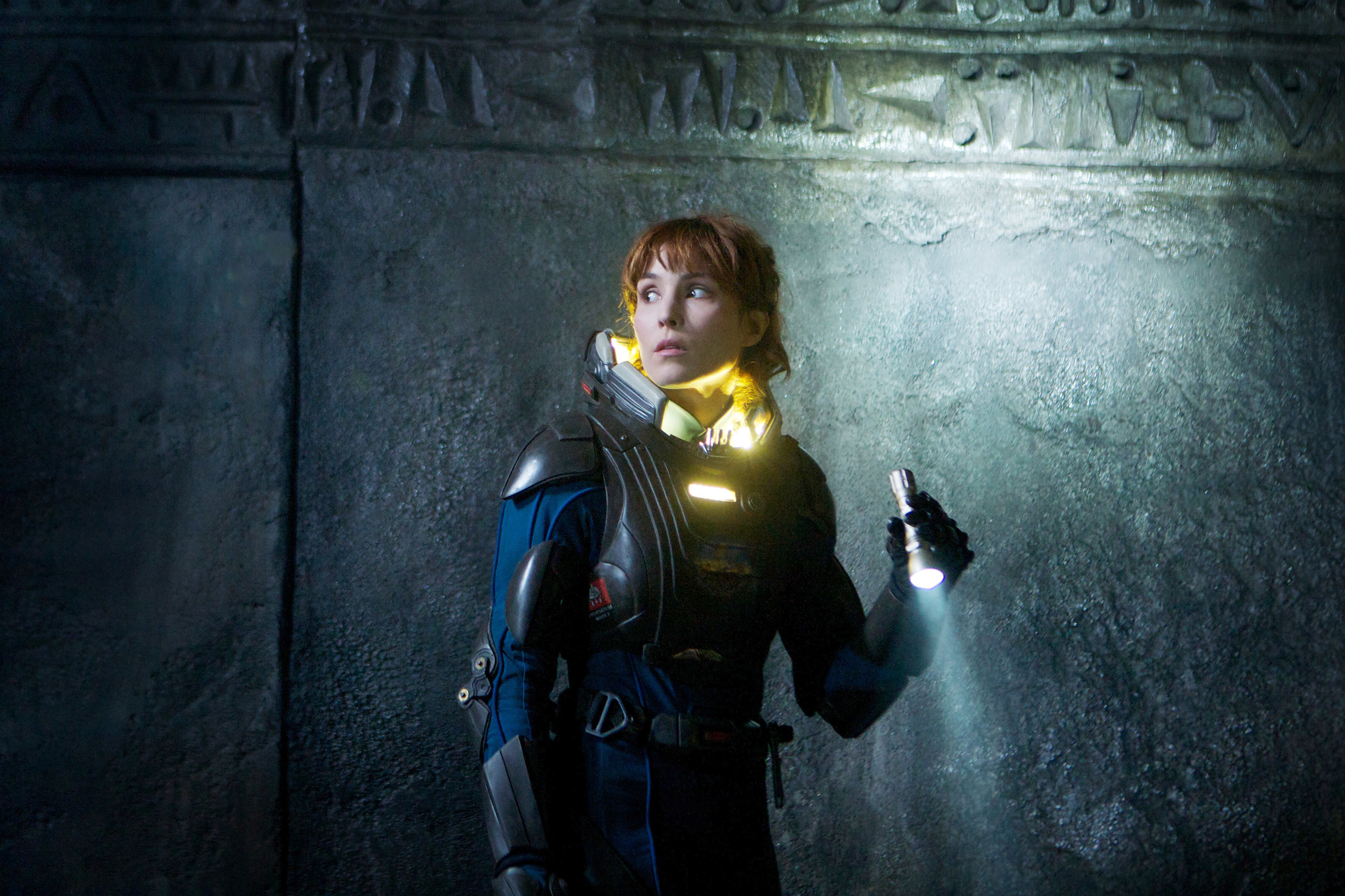 Noomi Rapace wears an astronaut suit and carries a flashlight