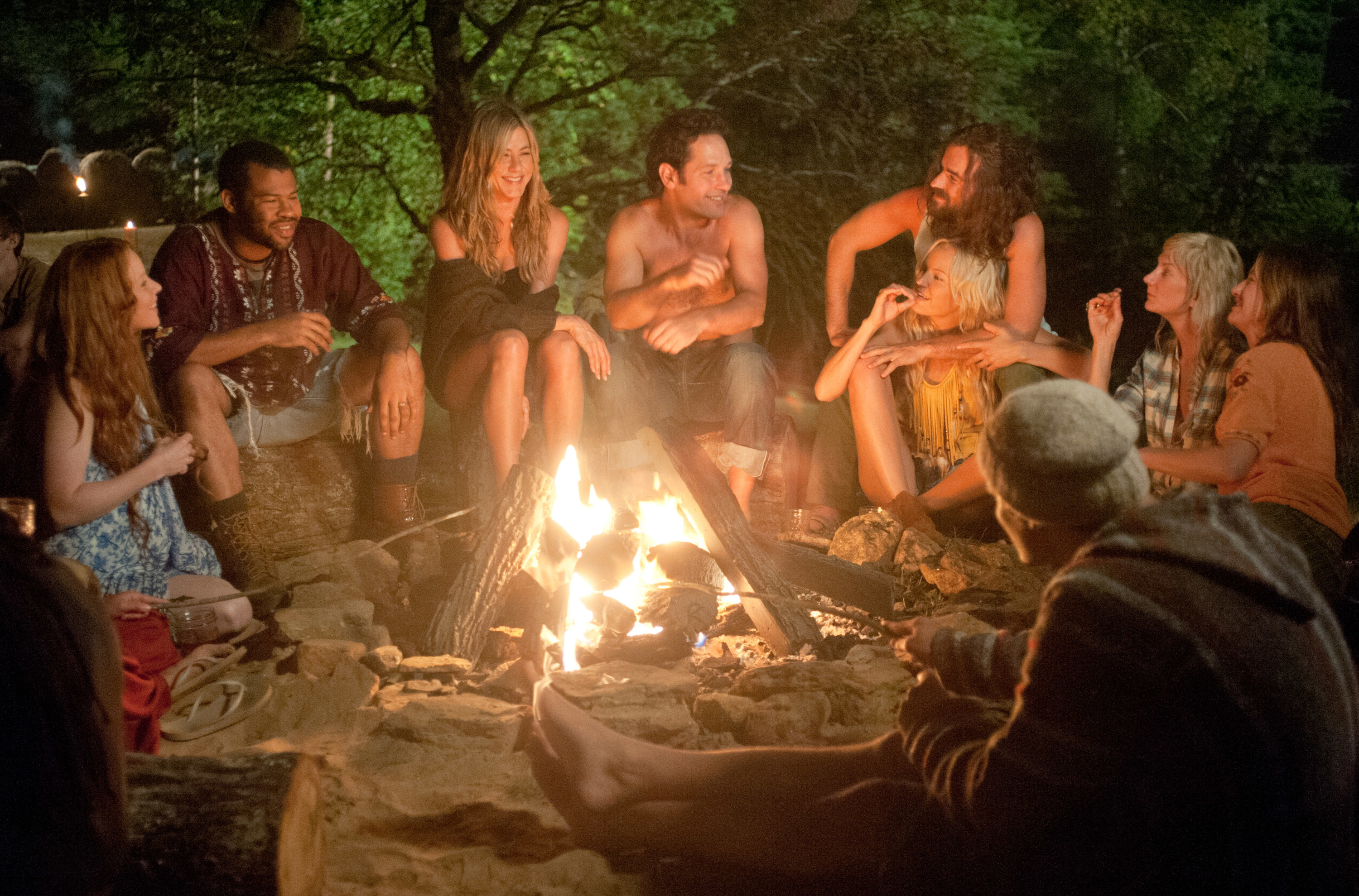 Jennifer Aniston and Paul Rudd sit around a campfire with Lauren Ambrose, Jordan Peele, Justin Theroux, Malin Akerman, Kerri Kenney, and Kathryn Hahn