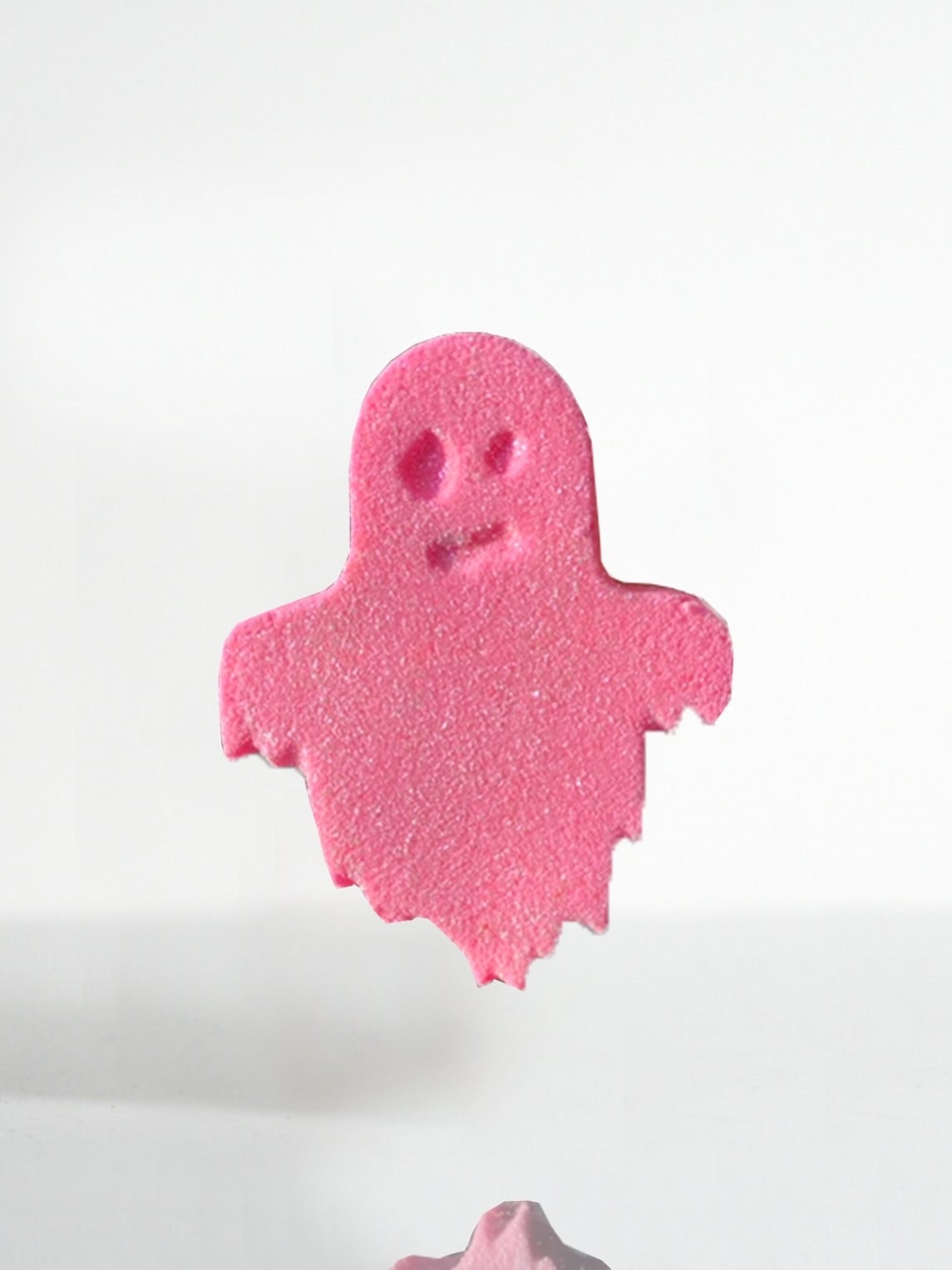 a pink ghost-shaped bath bomb