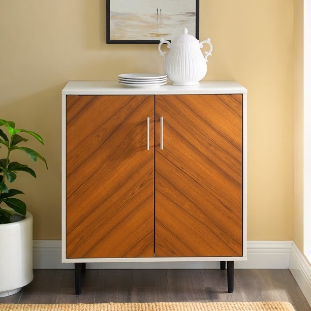 The accent cabinet with chevron wood pattern.
