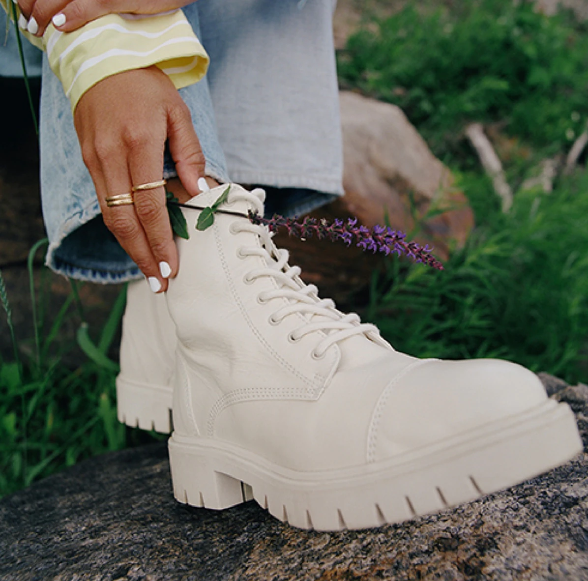 A person wearing chunky combat boots