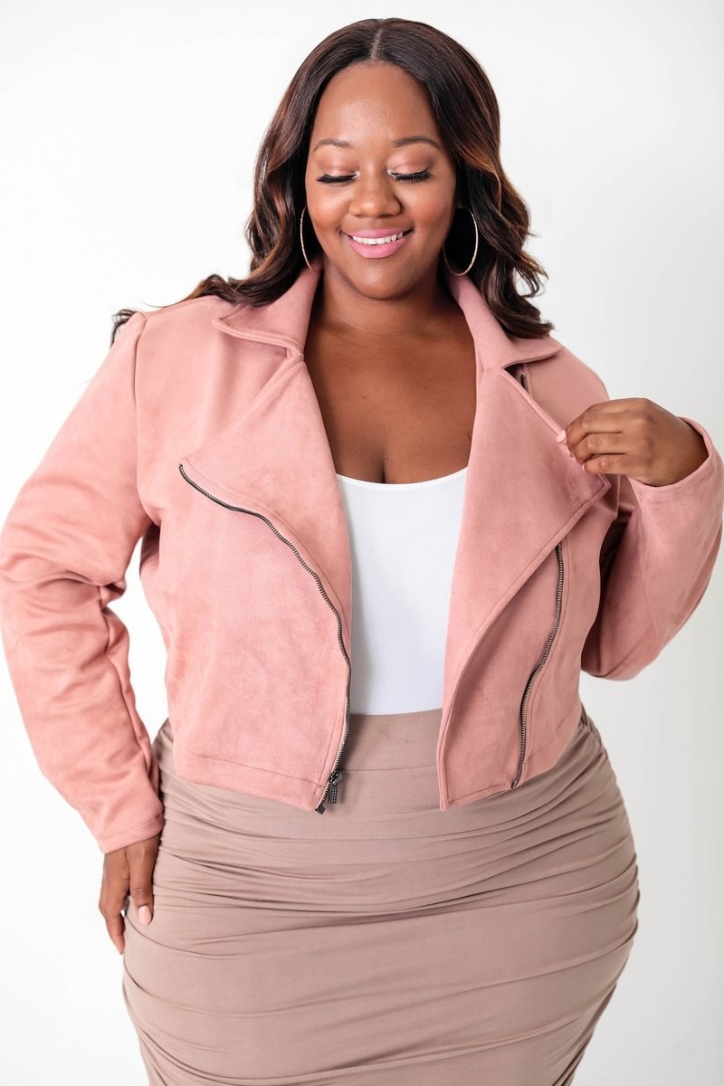 a model wearing the pink suede jacket with a zipper