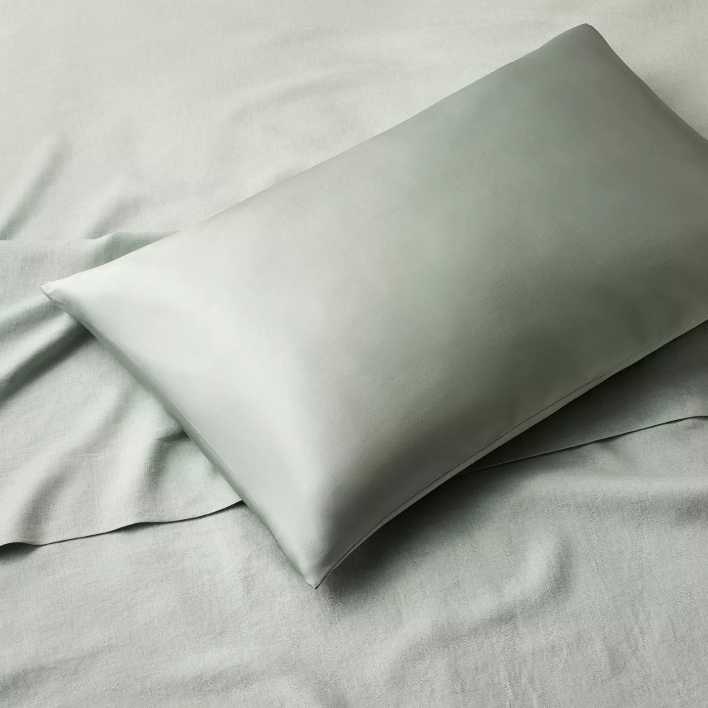 The silk pillowcase on a pillow in a bed