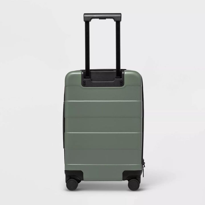 The suitcase on four wheels with an adjustable handle