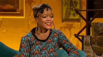 GIF of Rihanna throwing back her head and laughing