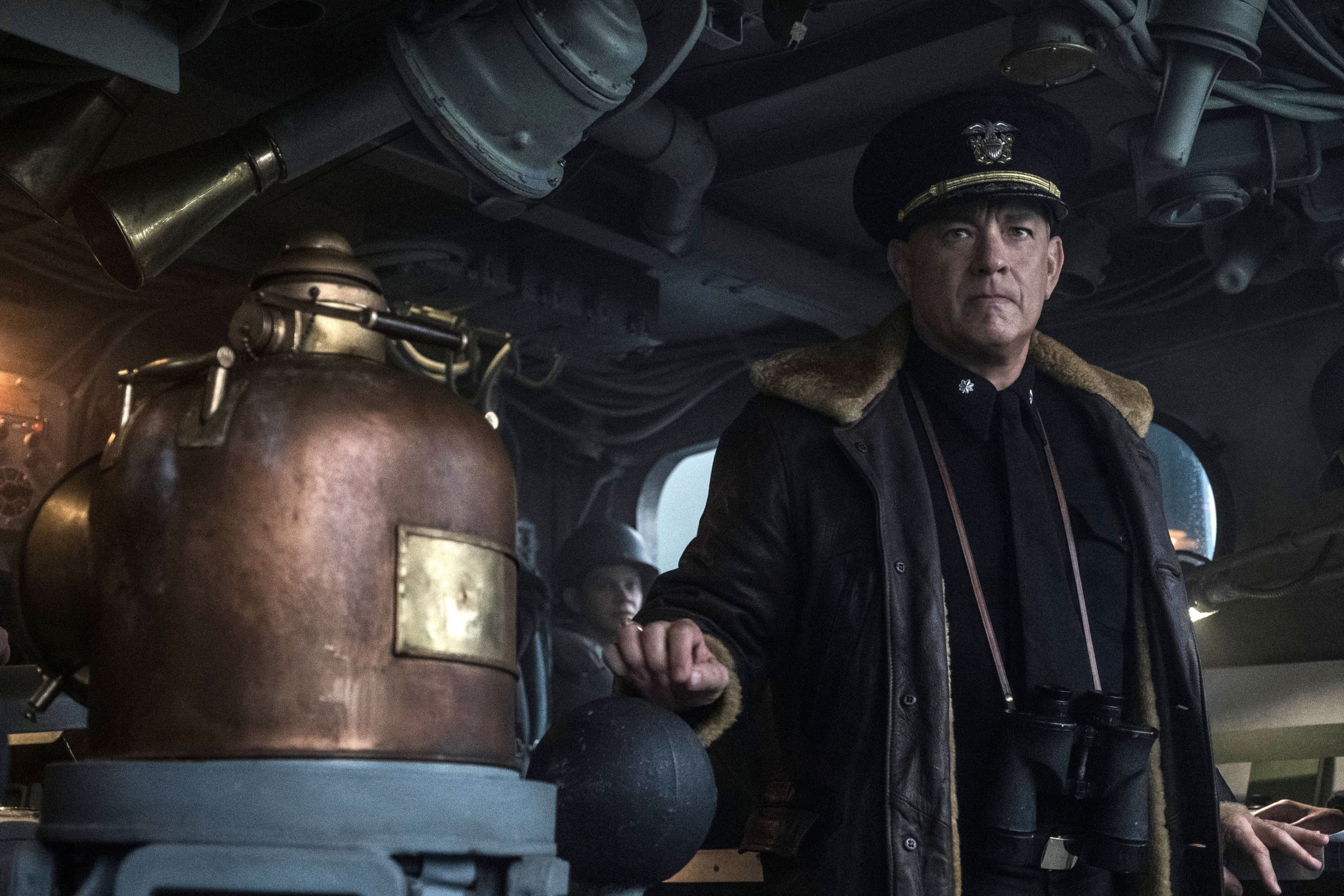 Tom Hanks stands in the hull of a ship
