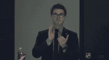 Kyle Dubas clapping while watching the game