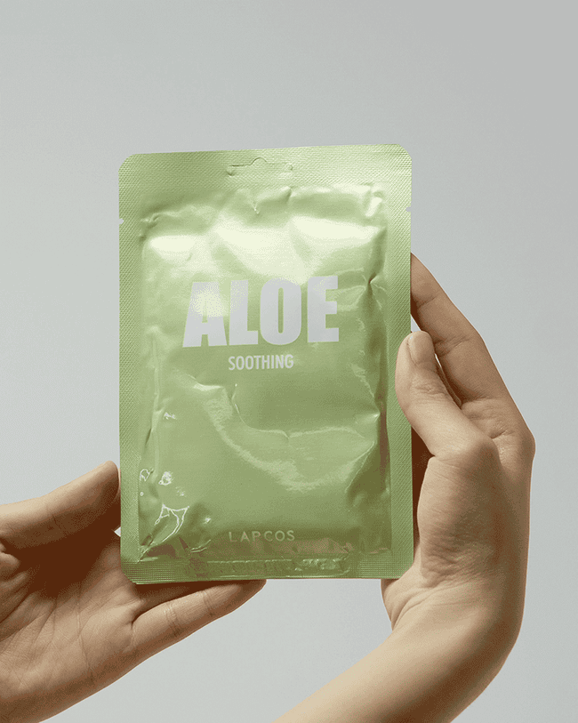 gif of someone unpacking an aloe sheet mask from a green foil packet