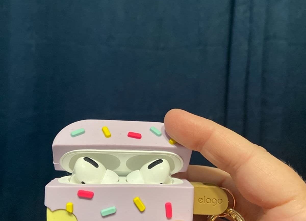 hand holds ice cream bar-shaped Air Pods case with AirPods and charging case inside of it