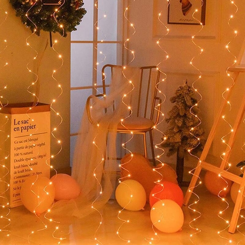 A set of spiral fairy lights in a room with balloons