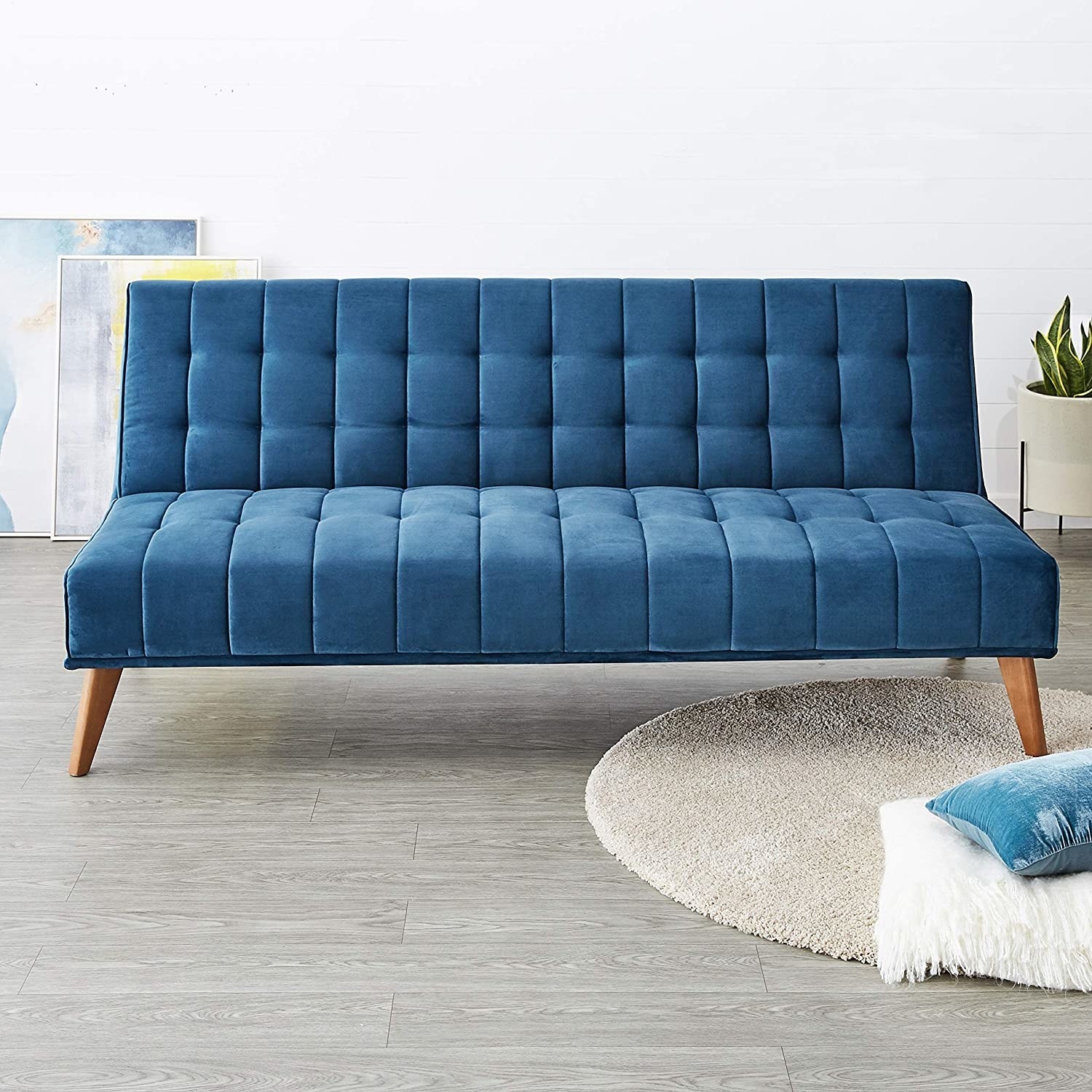 A three-seater blue sofa cum bed