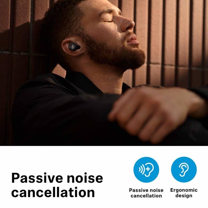 A man wearing wireless earphones with his eyes closed