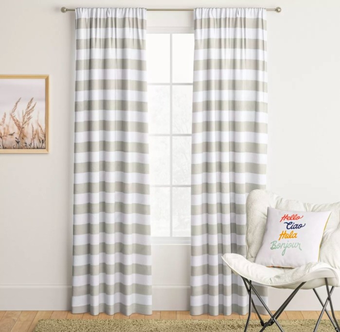 Two striped curtain panels hanging on a window