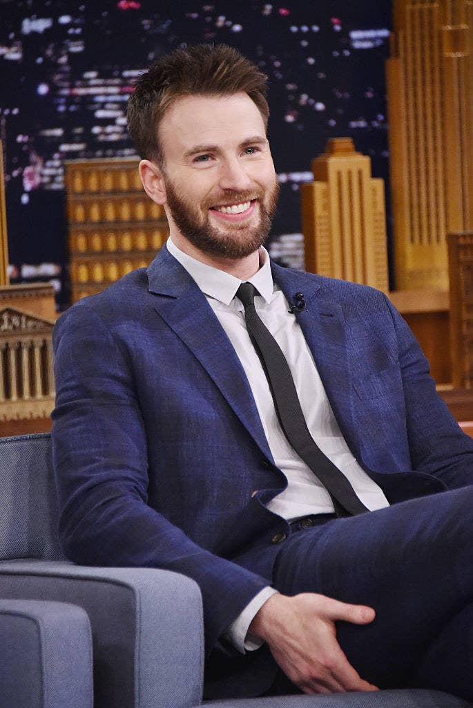 Chris smiles during a late-night TV show interview