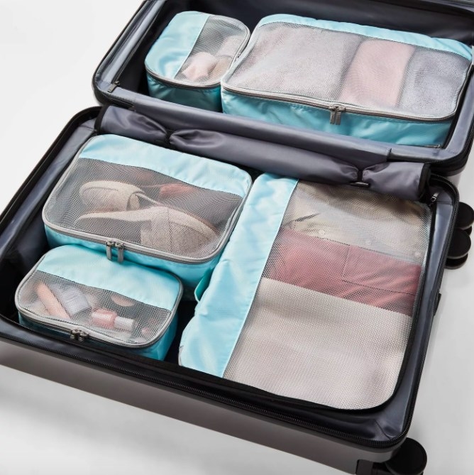 Packing cubes shown in an open suitcase