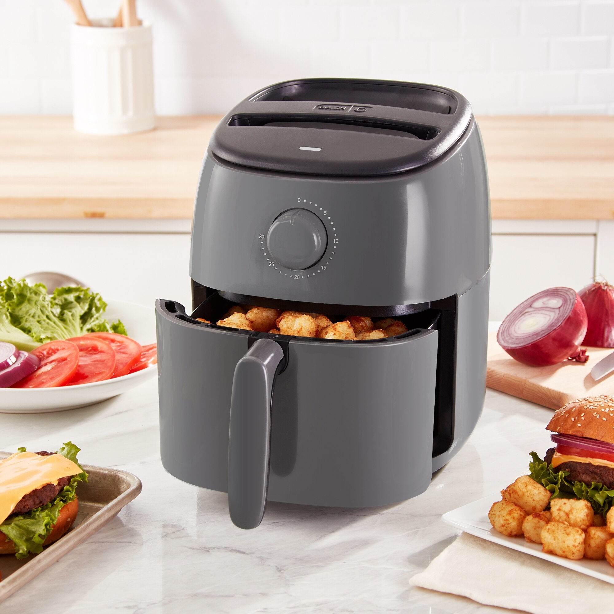 The air fryer with tater tots in the basket