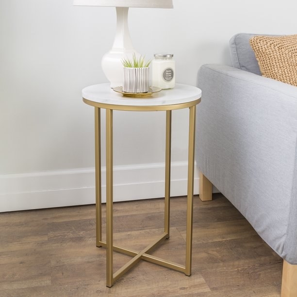 The gold and marble side table.