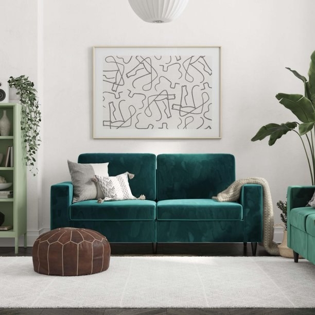 The emerald-colored sofa.