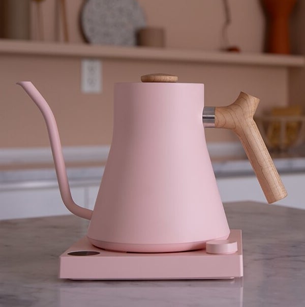 The kettle on its coaster on a marble counter