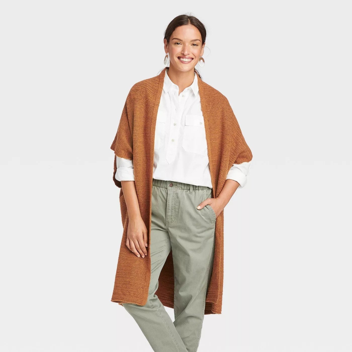 Model wearing camel duster, sleeves top at elbows