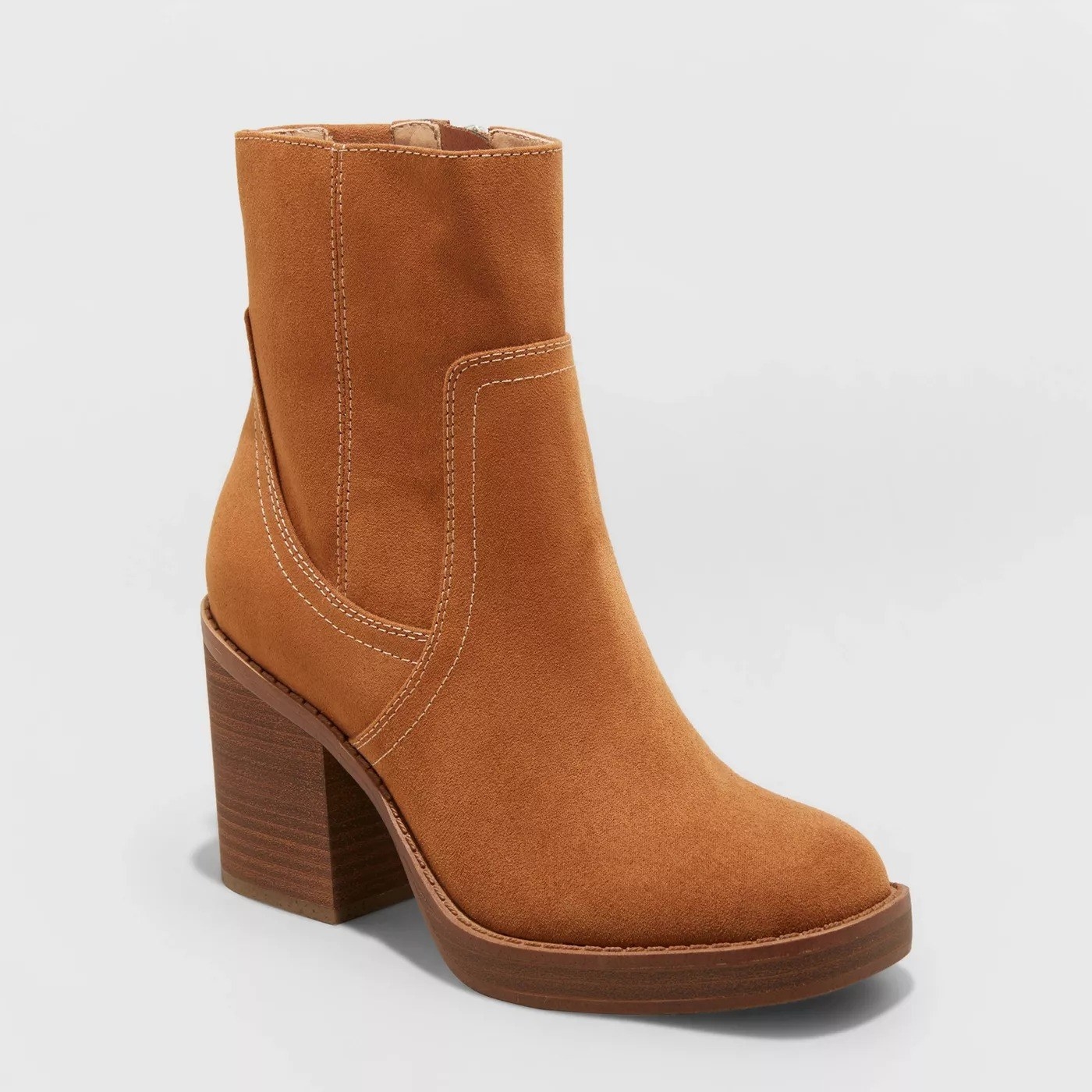 The camel colored heel boots, with light colored stitching, and block heel