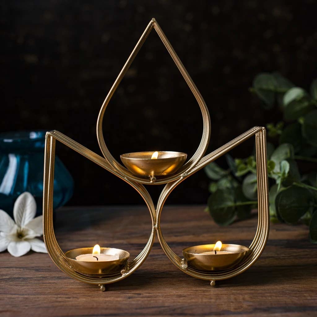 Three tealights balanced in teardrop shaped metal