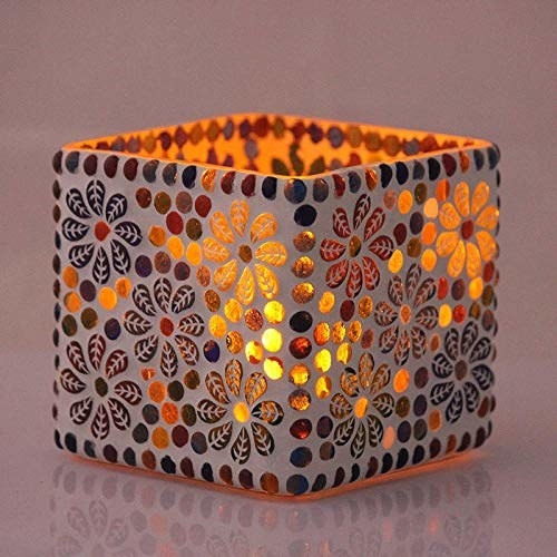 A square candle holder with a light in it