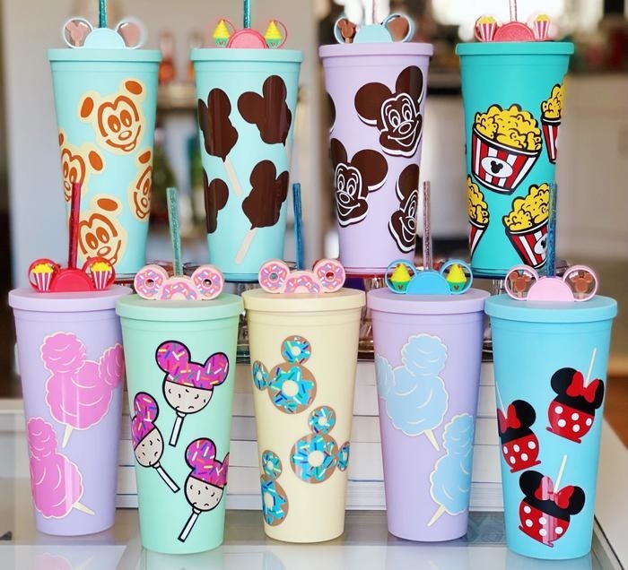 nine tumblers with an array of mickey mouse-shaped heads that are also designed as lollipops or donuts