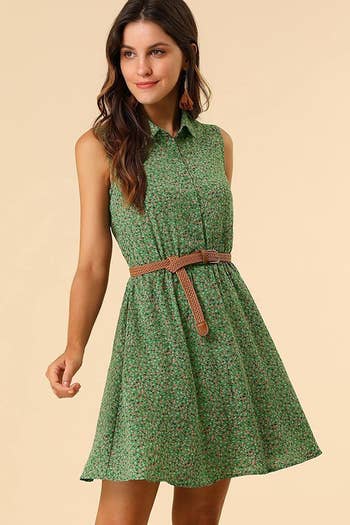 A model in the sleeveless collared dress with a brown braided belt in green and floral print