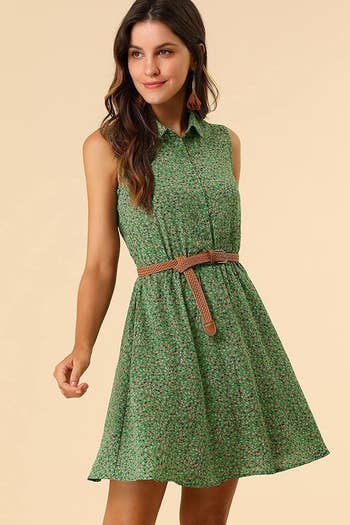A model in the sleeveless collared dress with a brown braided belt in green and floral print