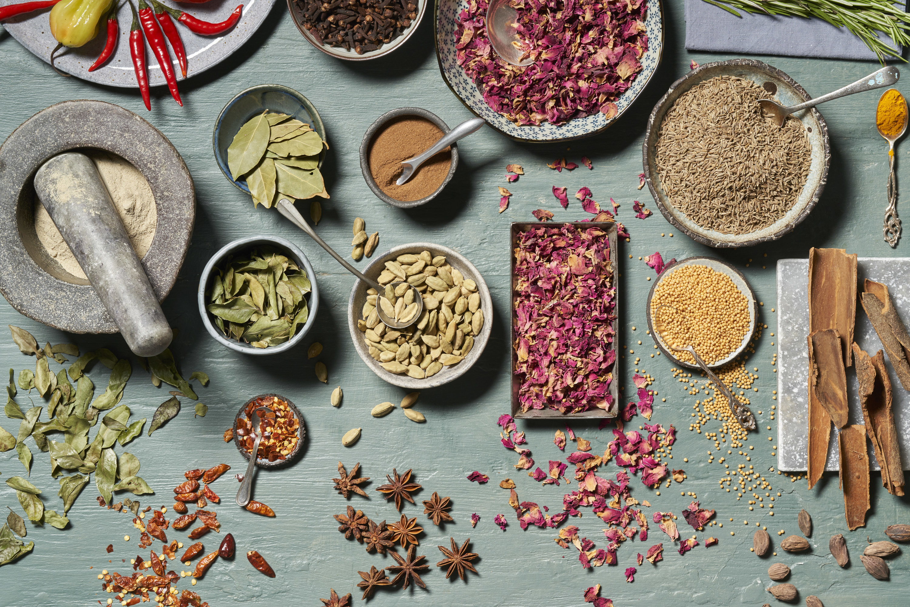 A variety of whole spices laid out on a table