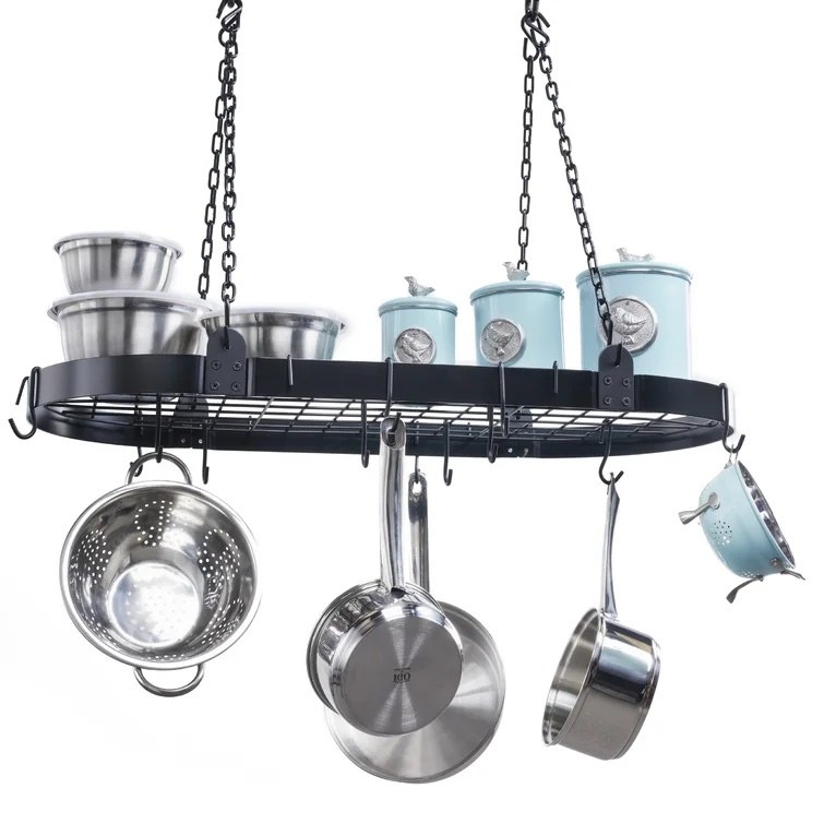 The rack holding various pots and pans via hooks, and some kitchen storage containers on top