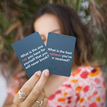 a model holding up two question cards