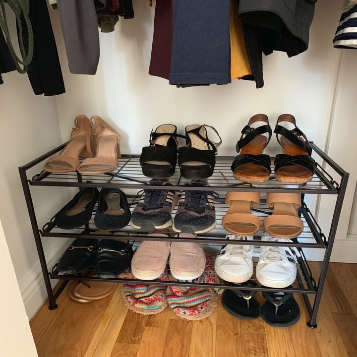 Reviewer photo of the shoe rack neatly holding many pairs of shoes in a closet