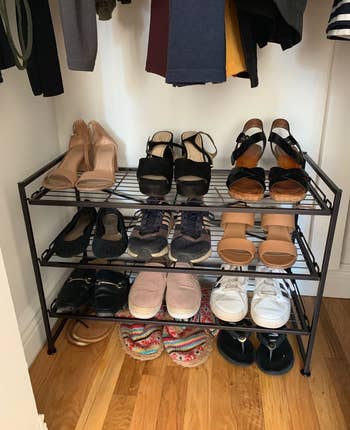 Reviewer photo of the shoe rack neatly holding many pairs of shoes in a closet