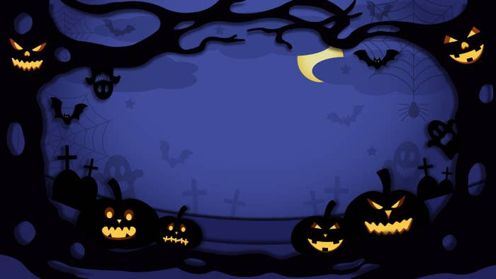 Lit jack-o-lanterns against a night sky
