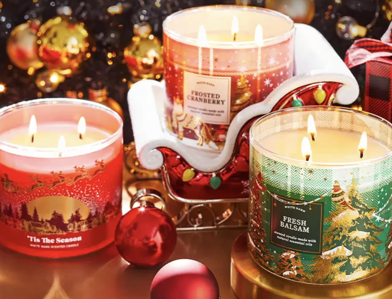 three holiday-themed three-wick candles