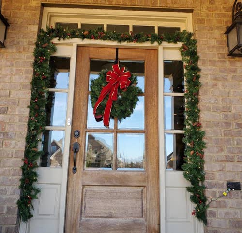 Reviewer photo of the garland framing the outside of their front door