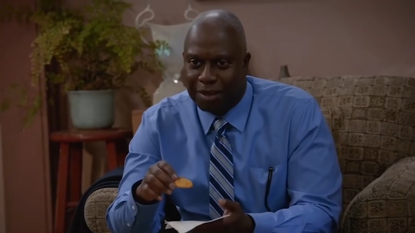 Holt watching television and eating in &quot;Brooklyn Nine-Nine&quot;