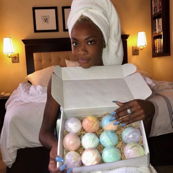 reviewer holds box of colorful bath bombs