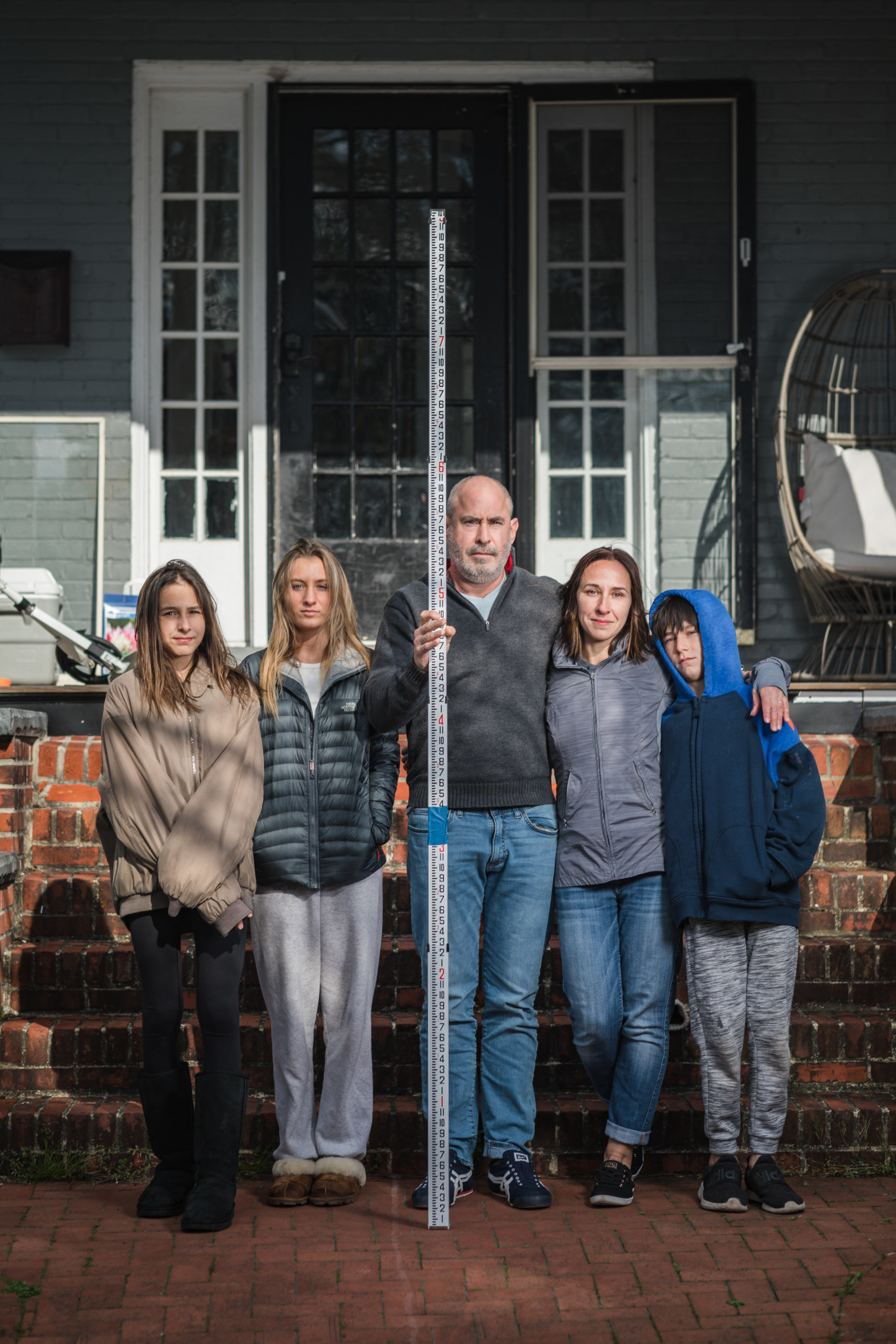 A family of five white people with their arms around each other