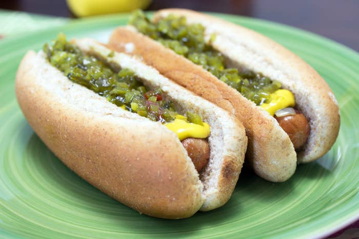 Two hot dogs with relish and mustard.