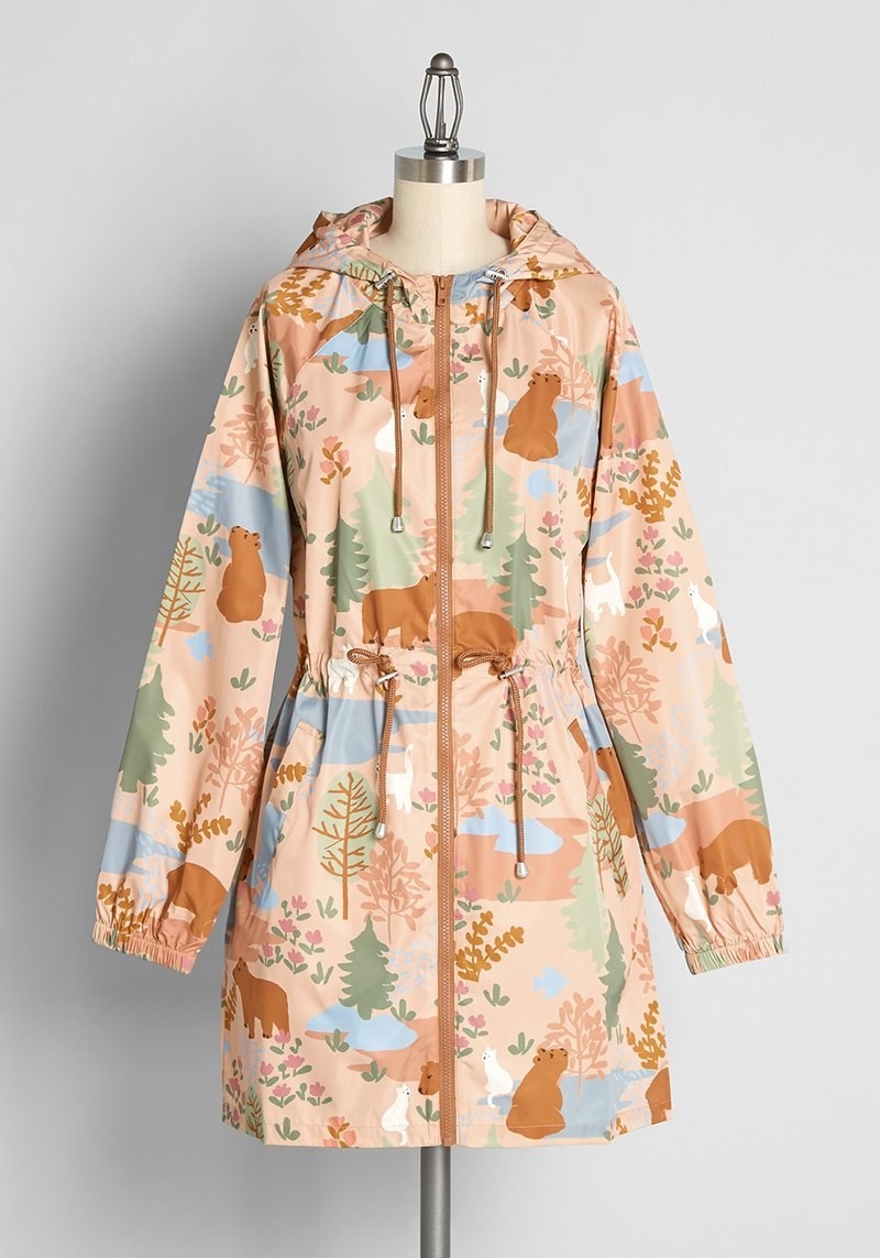 tan hooded jacket printed with bears and cats in the forest
