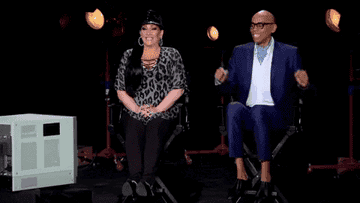 Gif of Michelle Visage and RuPaul bouncing in their seats excitedly