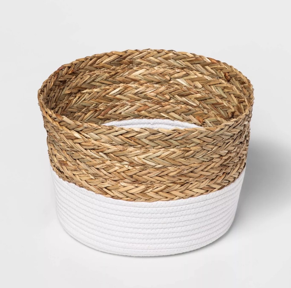 A braided and white coiled roped decorative basket
