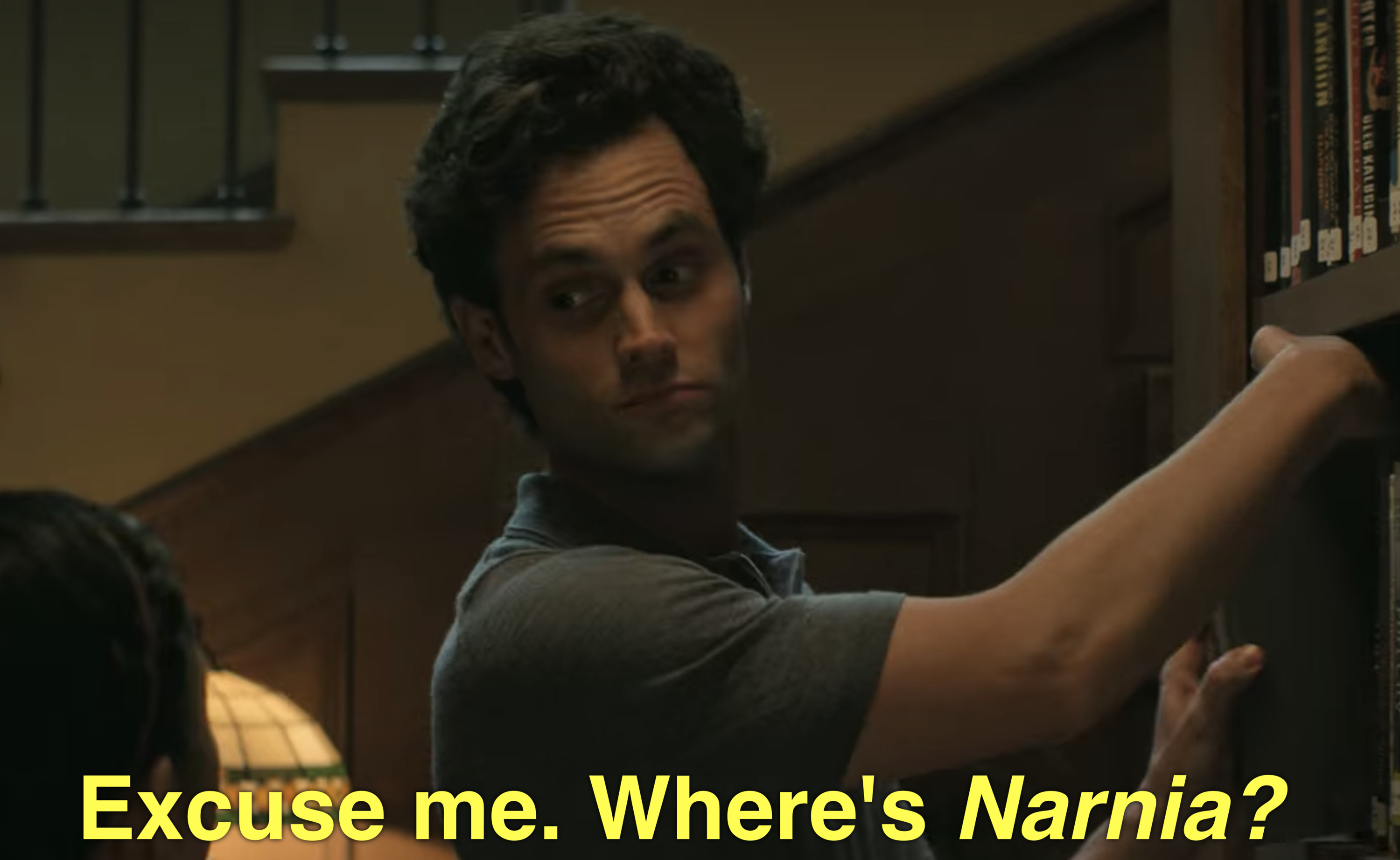 Joe shelves books while answering Where's Narnia question.