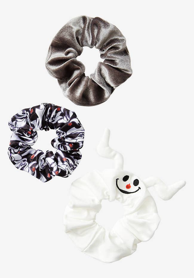 three scrunchies in grey, white, and a Zero pattern
